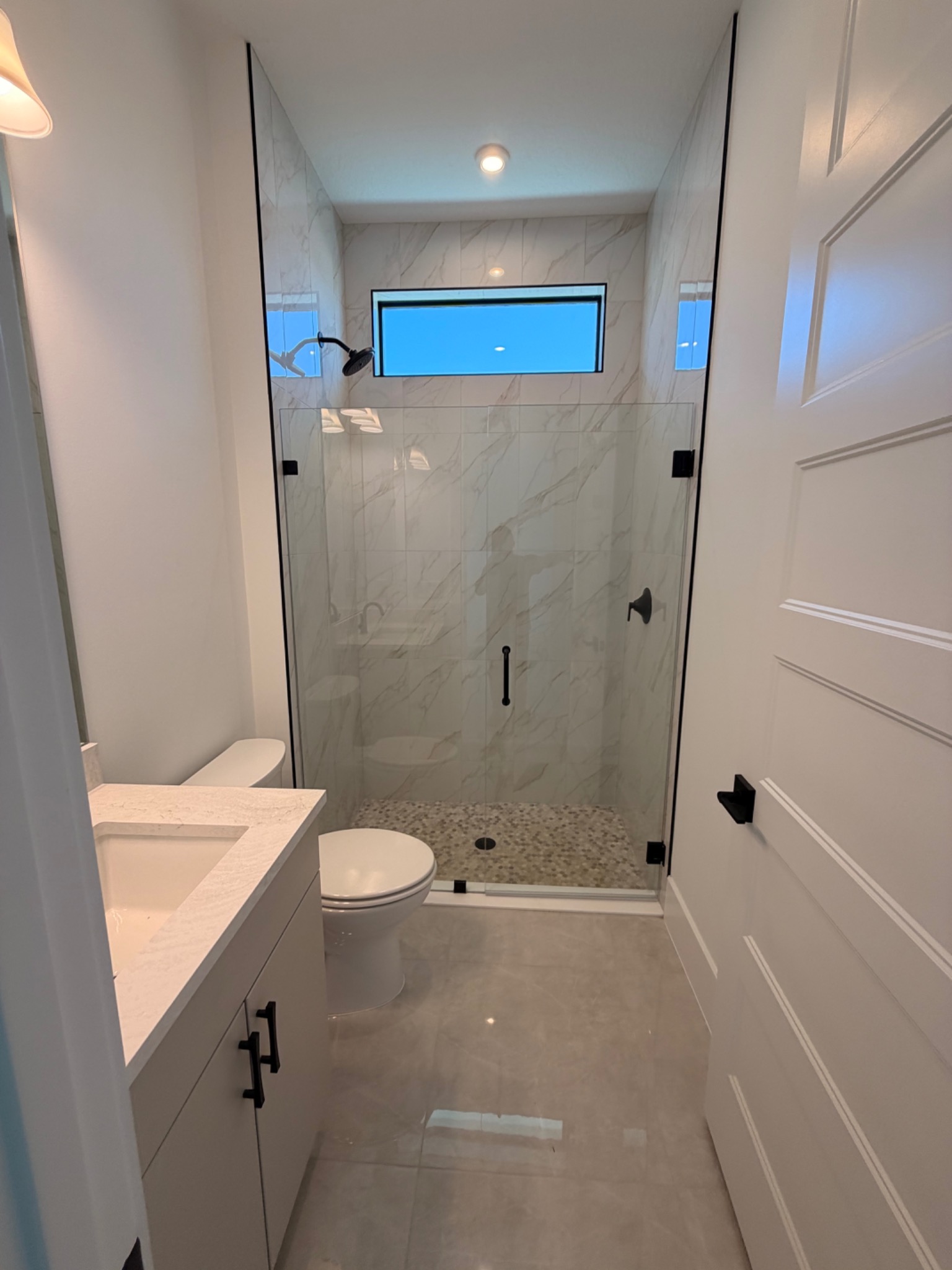 Completed guest bathroom with walk-in tile shower